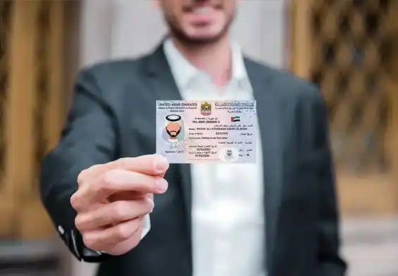 Businessman presenting Emirates ID at Quickplus Amer Center,
emphasizing reliable services.