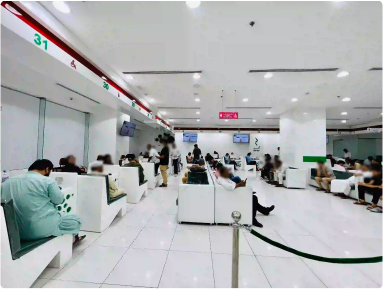 Bustling interior of Amer Center, Dubai, showing clients and

                            staff during service hours.